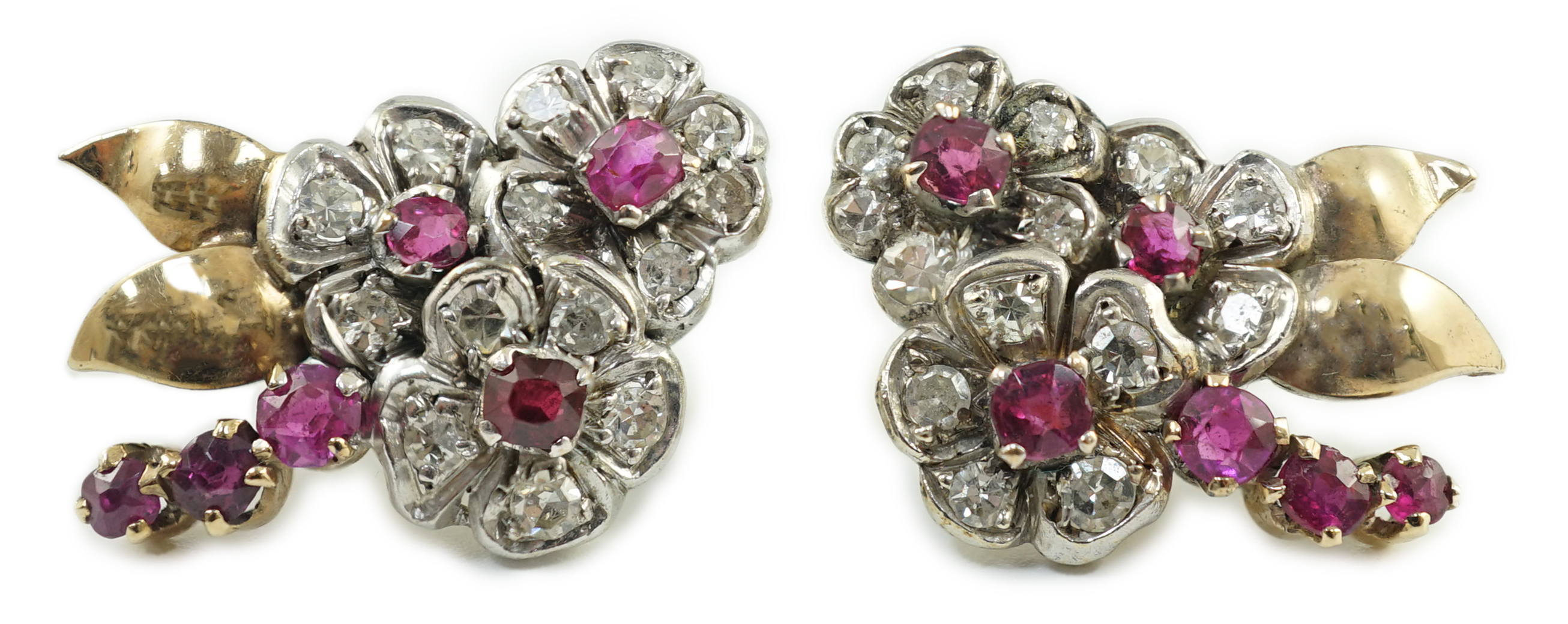 A pair of 1950's gold ruby and diamond set triple flower head cluster earrings